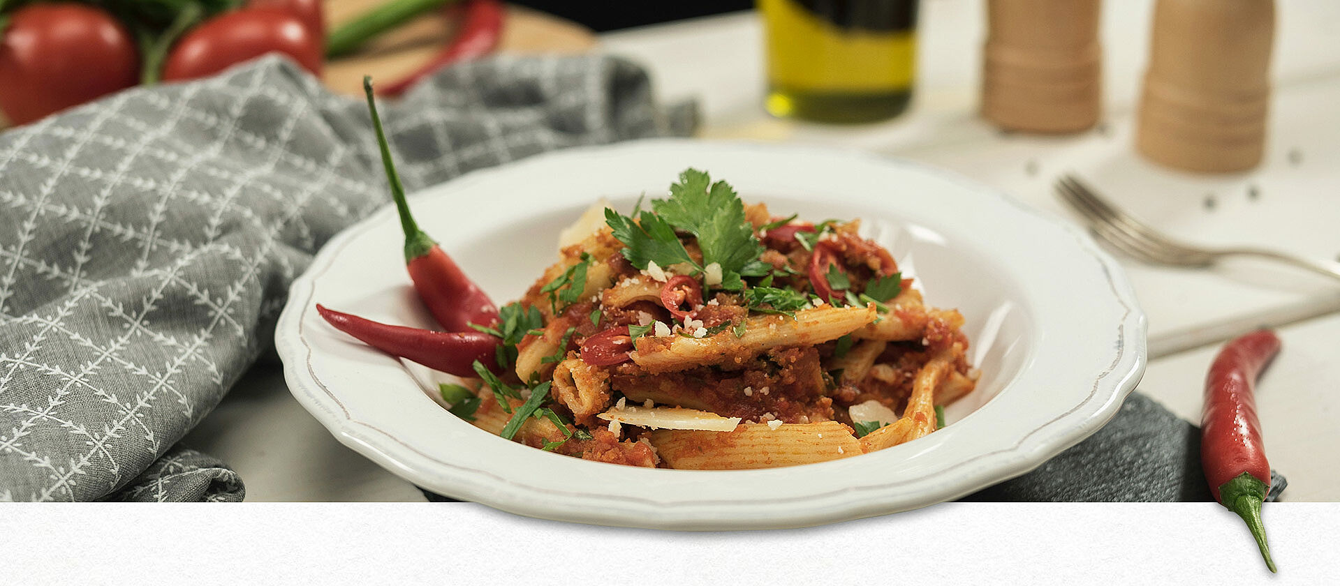 Penne all arrabbiata in a white plate.