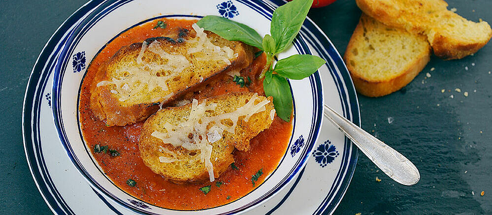 Venetian tomato soup in a white and blue bowl.