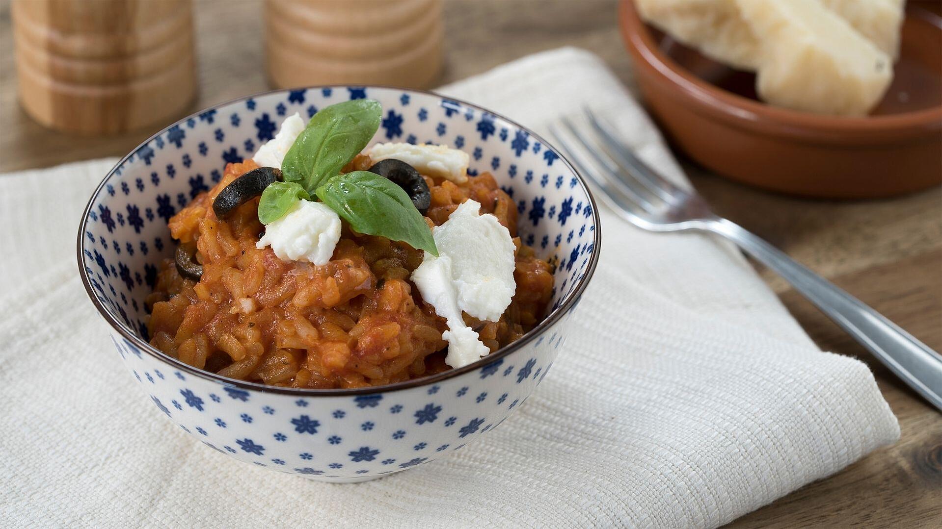 Alternativ-Text:	Eine Schale gefüllt mit Tomaten-Risotto, garniert mit Oliven, Mozzarella und Basilikum